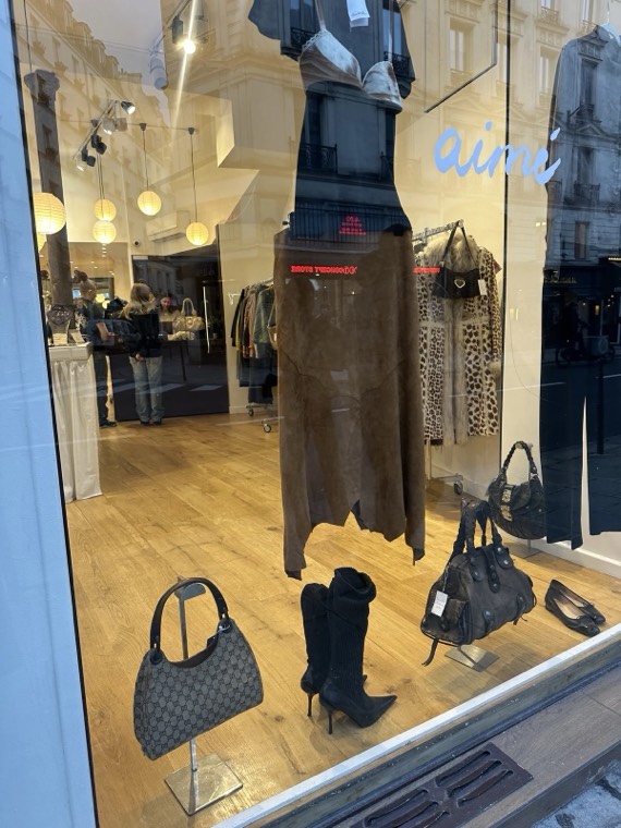 Boots, handbags and a leather skirt in a Paris boutique window