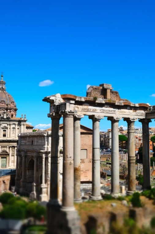Ruined columns in the Roman Forum under a blue sky