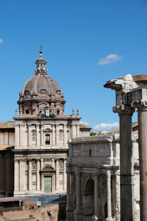 A domed church and an ancient arch beside the Roman Forum